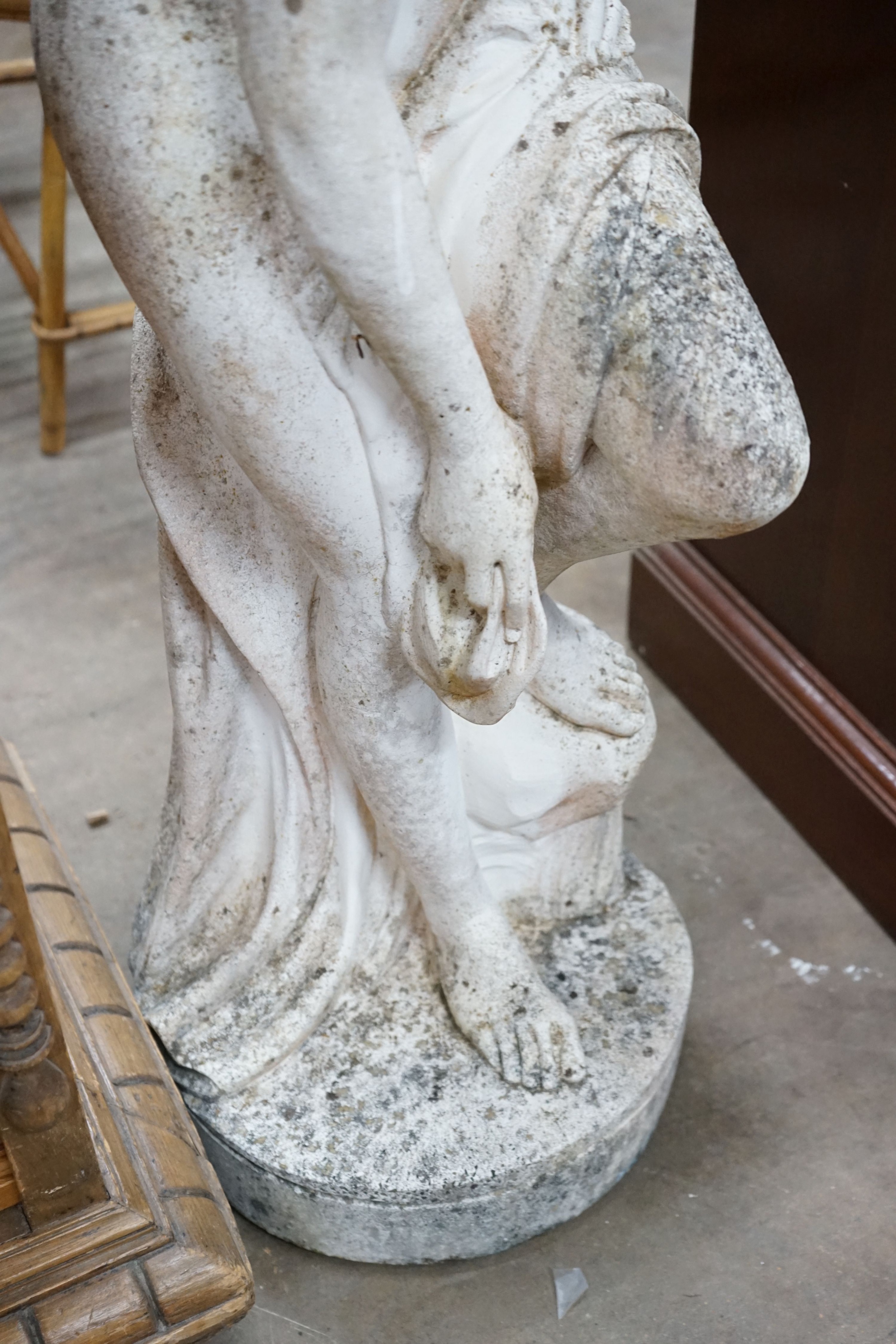 A reconstituted stone garden ornament of a female bather, height 102cm